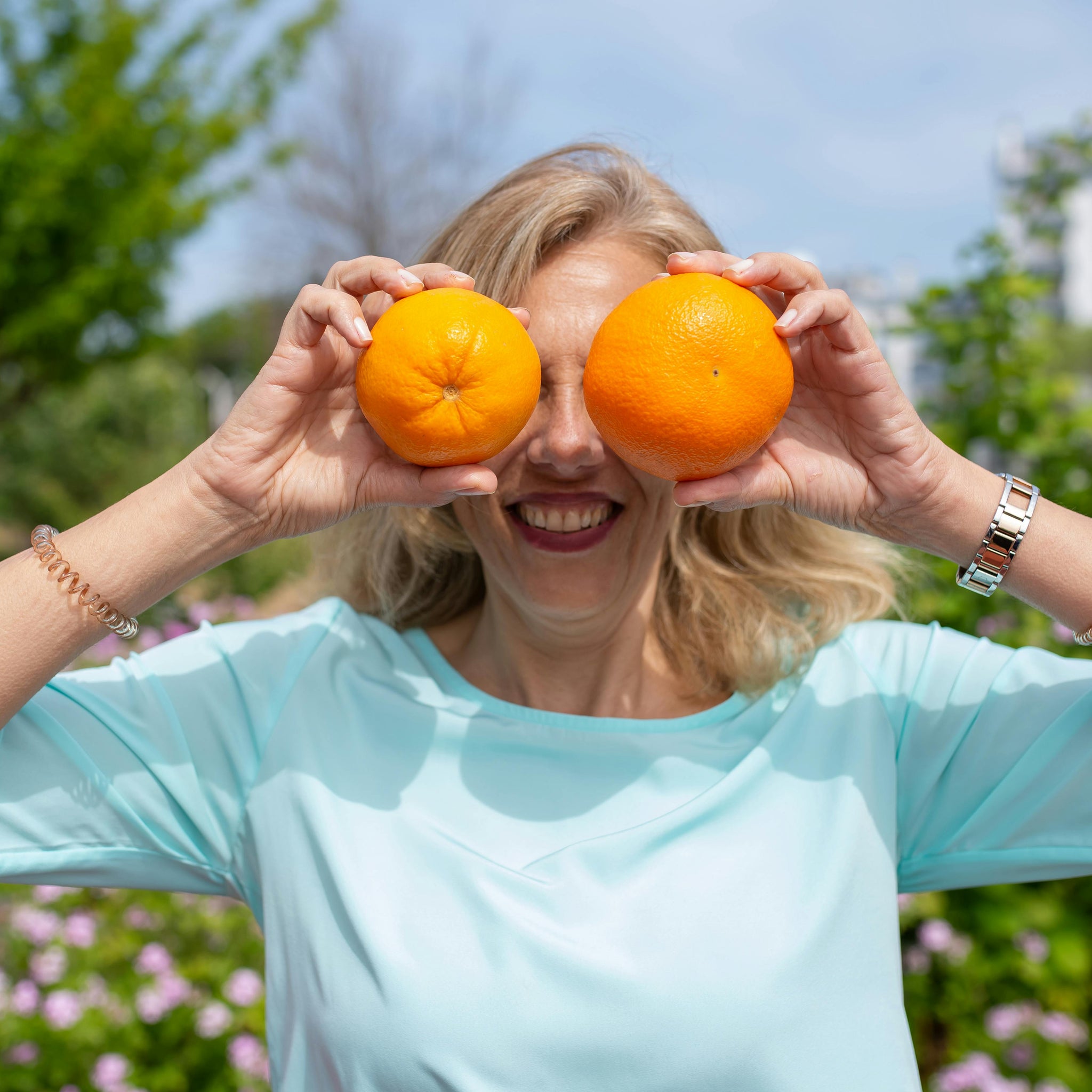 woman-holding-oranges-front-her-eyes