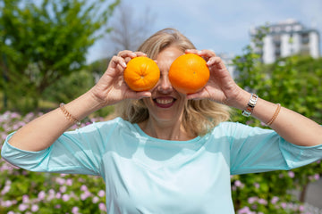 woman-holding-oranges-front-her-eyes