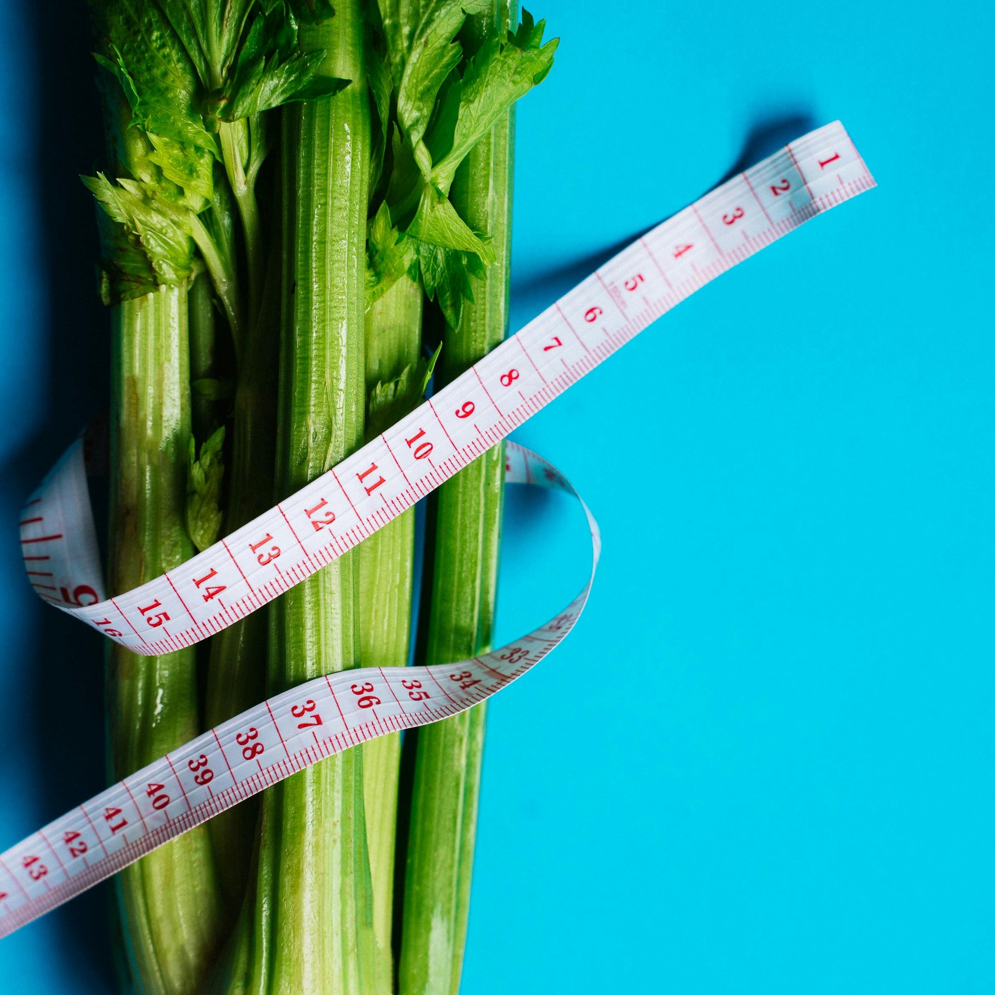 fresh celery stalks wrapped with a measuring tape