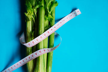 fresh celery stalks wrapped with a measuring tape